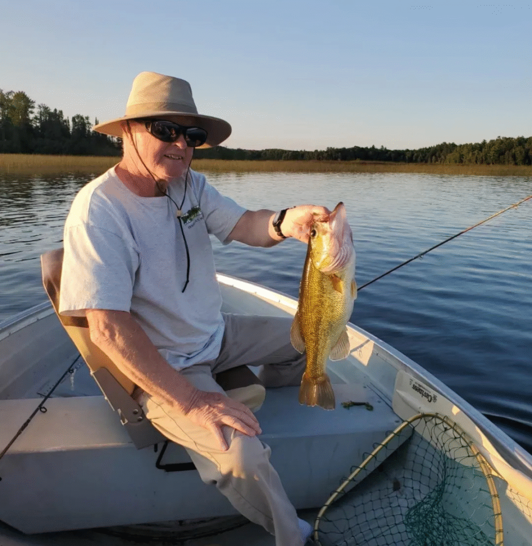 man holding fish bass trout muskey high lake musky lodge boulder junction Wisconsin