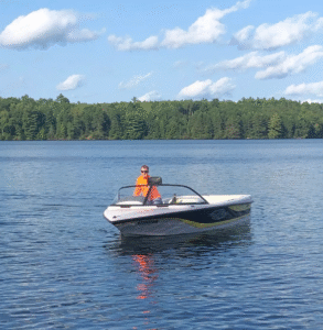 man driving boat high lake musky lodge boulder junction Wisconsin