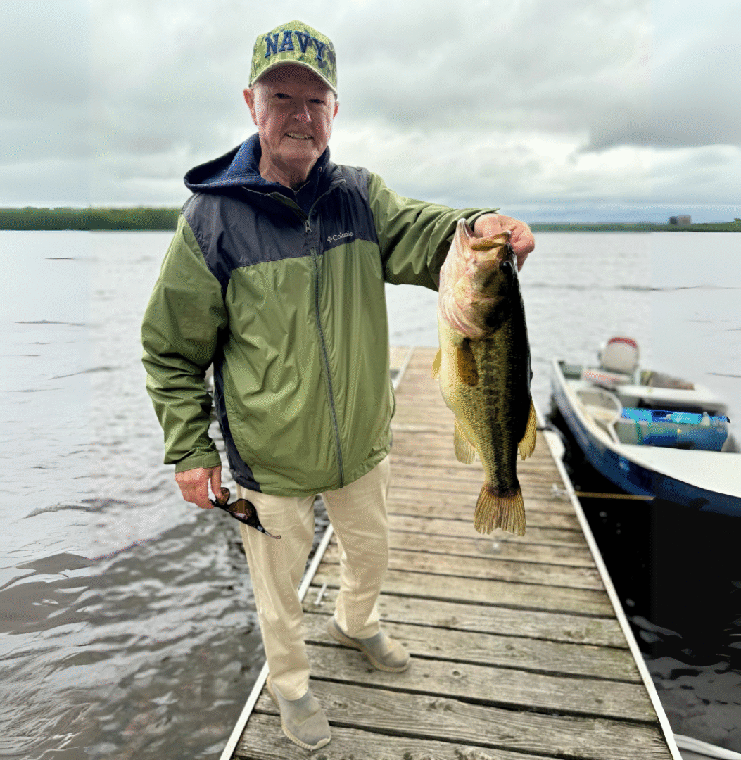 older man holding fish muskey high lake musky lodge boulder junction Wisconsin