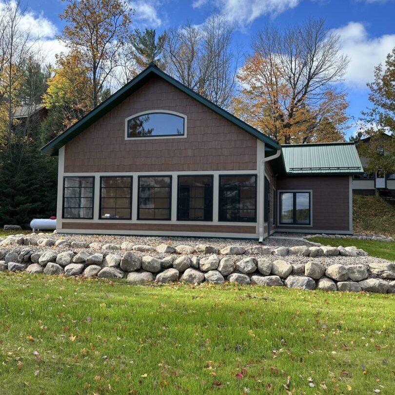 2023 White Pine pic1 A house with rocks and grass in front of it